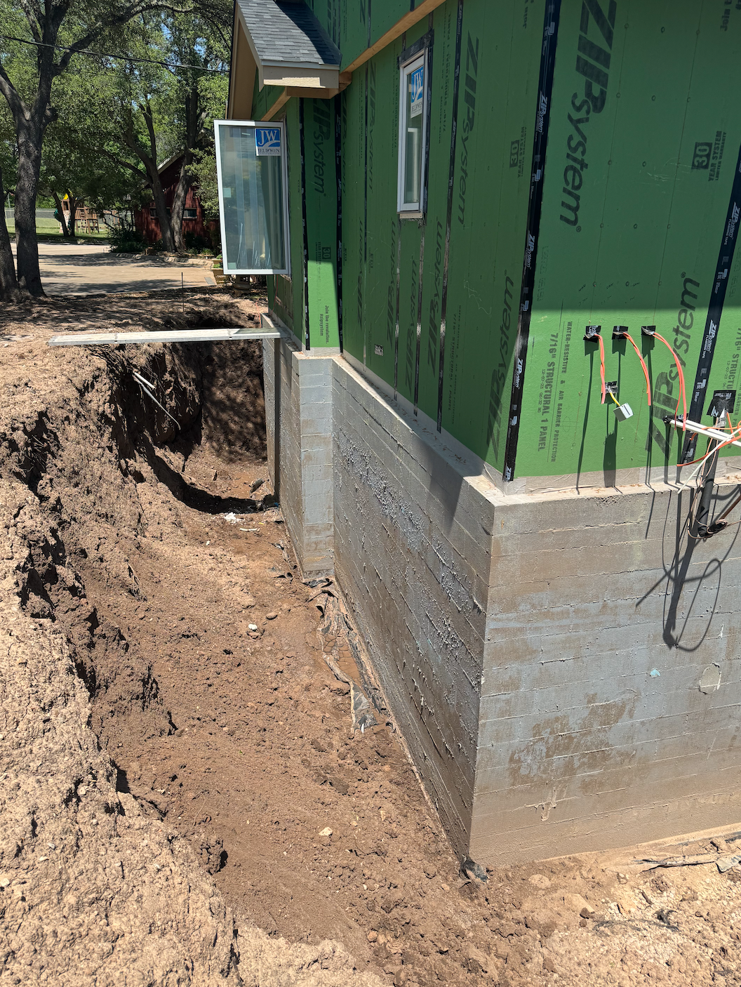 Exterior foundation waterproofing system applied to protect against water intrusion
